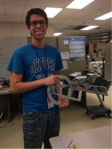 Natã is holding the structure he designed for the SuperORRUBA detectors.